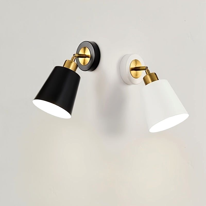 Two Luna Glow adjustable wall sconce lights, one in white and one in black, both featuring brushed metal and brass accents, illuminated on a white wall. Ideal for modern home decor.