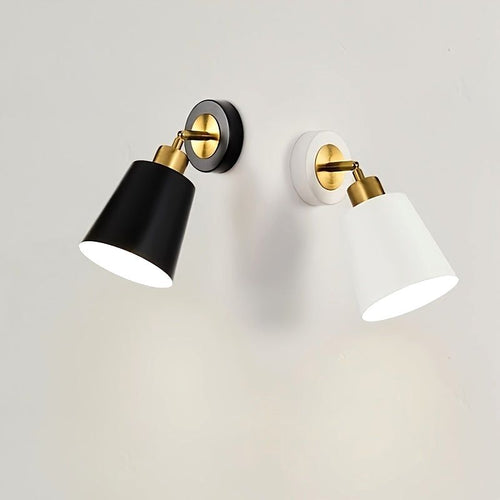 Two Luna Glow adjustable wall sconce lights, one in white and one in black, both featuring brushed metal and brass accents, illuminated on a white wall. Ideal for modern home decor.
