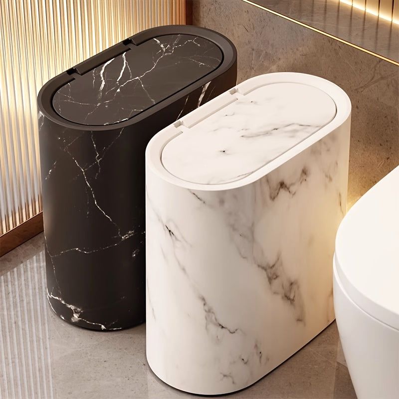 Two Luxe Marble Canisters, one in Cream White and one in Marble Black, standing in a modern bathroom. These stylish waste bins offer an elegant trash solution for contemporary decor.