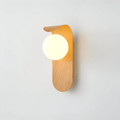 A close-up of the Nordic Glow LED wall sconce in light wood, illuminated and mounted on a plain white wall, highlighting its minimalist design.