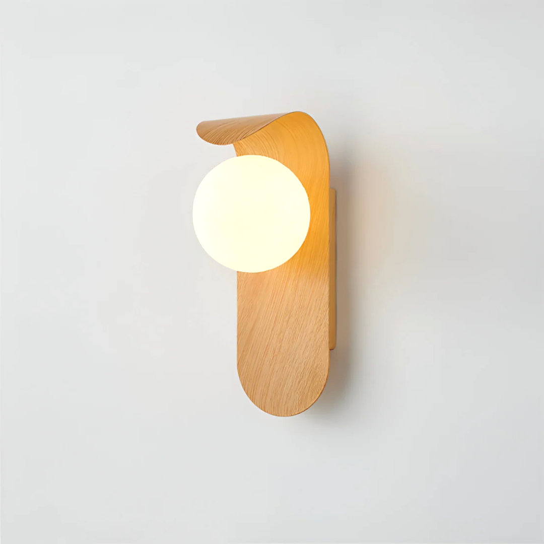 A close-up of the Nordic Glow LED wall sconce in light wood, illuminated and mounted on a plain white wall, highlighting its minimalist design.